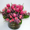 Pink tulips and spray roses in a glass vase