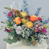 Colorful mixed flower arrangement in a white vase