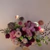 Mixed pink and burgundy bouquet in a decorative glass vase