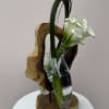 A sleek floral arrangement featuring elegant white calla lilies artfully displayed in