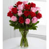 Bouquet of red and pink roses in a clear glass vase