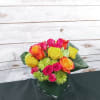 Bright mixed rose bouquet in a square glass vase
