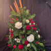Tall floral arrangement with red and white blooms and evergreen foliage