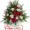Metal sleigh filled with Christmas green and flowers