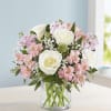 Pink and white bouquet of roses and alstroemeria in a clear glass vase