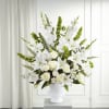 White floral arrangement in a white urn vase