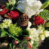 Bouquet of red roses, white hydrangea, and white lilies with a pinecone centerpiece