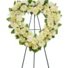 Heart-shaped white floral wreath on a standing easel