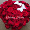Heart-shaped bouquet of red roses with two white butterflies