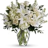 White lilies and roses arranged in a clear glass vase