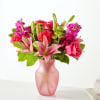 Pink and red mixed bouquet in a frosted pink vase