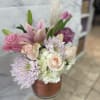 Pink and white bouquet in a copper-toned vase