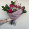1 dozen elegant hot pink roses wrapped in premium bouquet paper tied