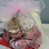 Gift basket with pink and white balloons wrapped in tulle