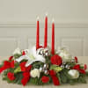 Red and white floral centerpiece with three red candles