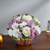 Basket of white and purple flowers with roses and daisies