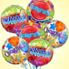 Cluster of colorful congratulatory balloons with star patterns
