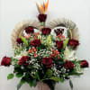 Basket arrangement of red roses, white lilies, and bird of paradise