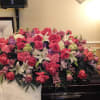 Large pink and white floral casket spray with roses and lilies