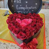 Heart-shaped box of red and pink roses with a birthday sign