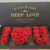 Red roses arranged in a gift box spelling "I LOVE U"