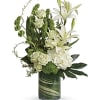 White lilies and roses arranged in a green glass vase