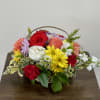 Basket arrangement of mixed roses, carnations, and daisies