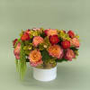 A striking luxury arrangement featuring premium garden roses in warm sunset shades