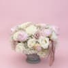 Pink and white rose bouquet in a gray pedestal vase