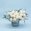 White rose bouquet in a silver vase with a blue ribbon