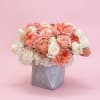 Peach and white rose arrangement in a gray geometric vase