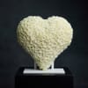 Heart-shaped arrangement of white roses on a stand