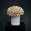 Round bouquet of pale pink roses in a white hat box
