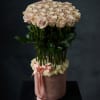 Round bouquet of pale pink roses in a pink hatbox with a ribbon