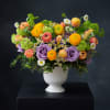 Colorful mixed bouquet in a white pedestal vase