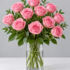 Pink roses arranged in a clear glass vase