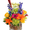 Colorful birthday bouquet in a glass vase with a "Happy Birthday" topper