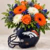 Orange and white flowers arranged in a Denver Broncos football helmet
