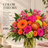 Bright mixed bouquet in a clear glass vase with pink and orange flowers