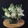 Soft and sophisticated, this arrangement of whites, creams and greens leave you