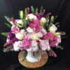 This bountiful arrangement is full of soft tones of pink and white