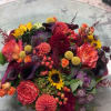 Colorful mixed bouquet with roses, dahlias, sunflowers, and calla lilies