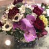 Bouquet of burgundy roses, white anemones, and purple orchids with succulents