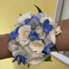 White and blue rose wrist corsage with silver ribbon