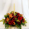 Enchanting centerpiece with a candle, red roses, rich colored seasonal mums, and