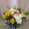 Bouquet of pink and yellow roses with white daisies in a glass vase