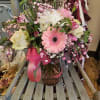 Pink and white mixed bouquet in a glass vase with a ribbon