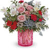 Pink and red rose bouquet in a pink glass vase