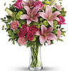 Pink lilies and roses in a clear glass vase