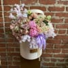 Pastel rose bouquet in a white hat box with a lavender ribbon